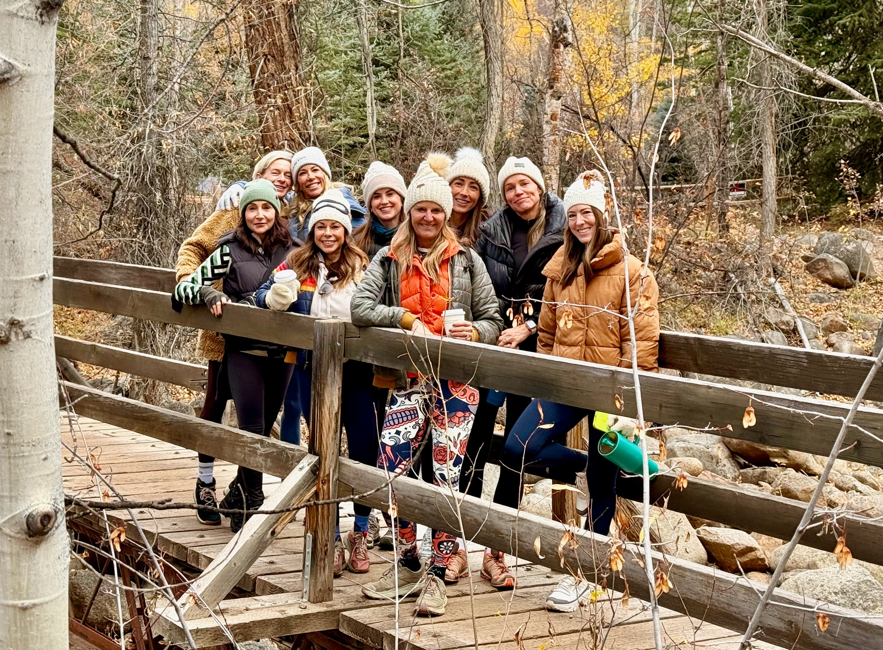 The Loop retreat group on a footbridge amid the Aspen fall foliage